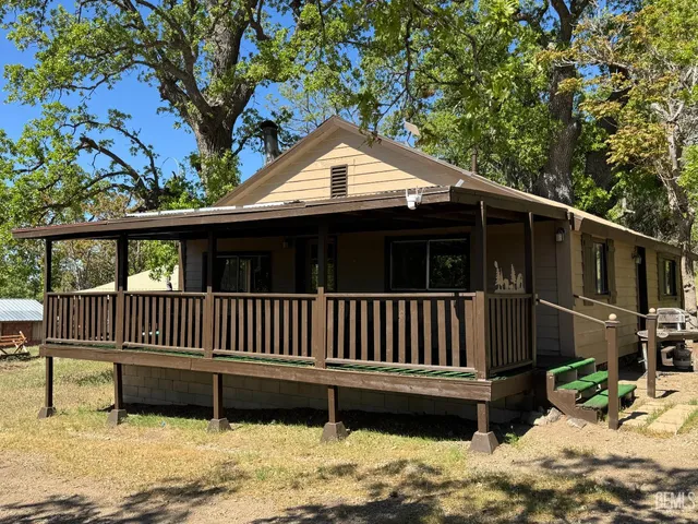 a view of a wooden deck and a yard