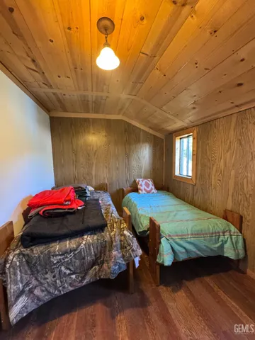 a bedroom with two beds and a chandelier