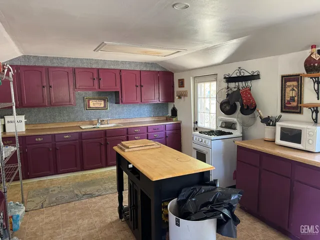 a kitchen with a sink cabinets and window