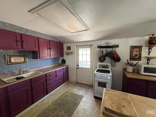 a kitchen with stainless steel appliances granite countertop a stove sink and cabinets