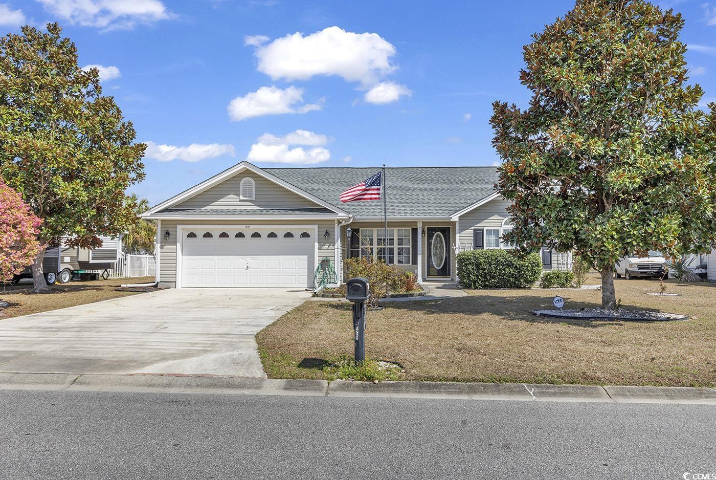Ranch-style house featuring a front yard, concrete