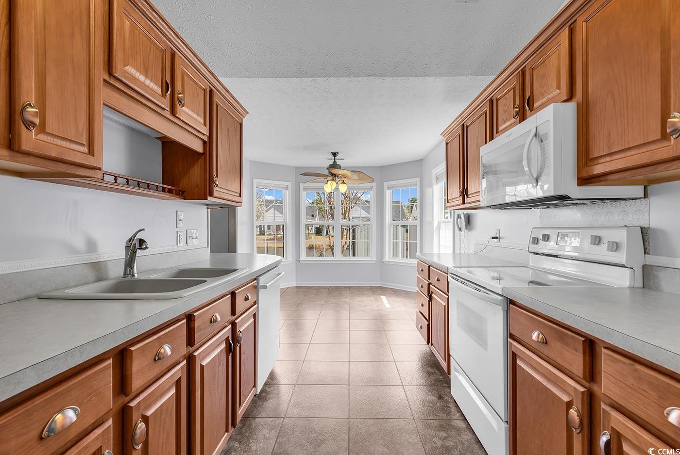 1336 Gailard Drive Conway, SC 29526 - Photo 19 of 39 Kitchen with dark tile patterned flooring, brown c