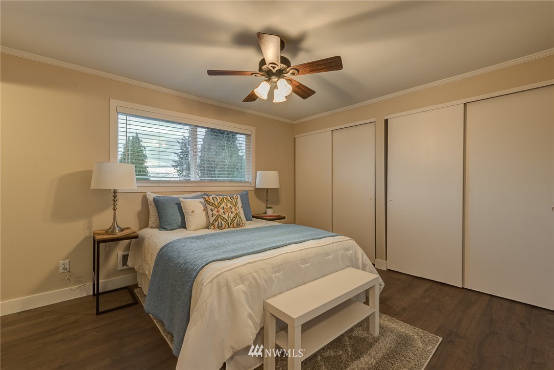 4314 Southwest Frontenac Street Seattle, WA 98136 - Photo 15 of 32 a bedroom with a bed and a chandelier