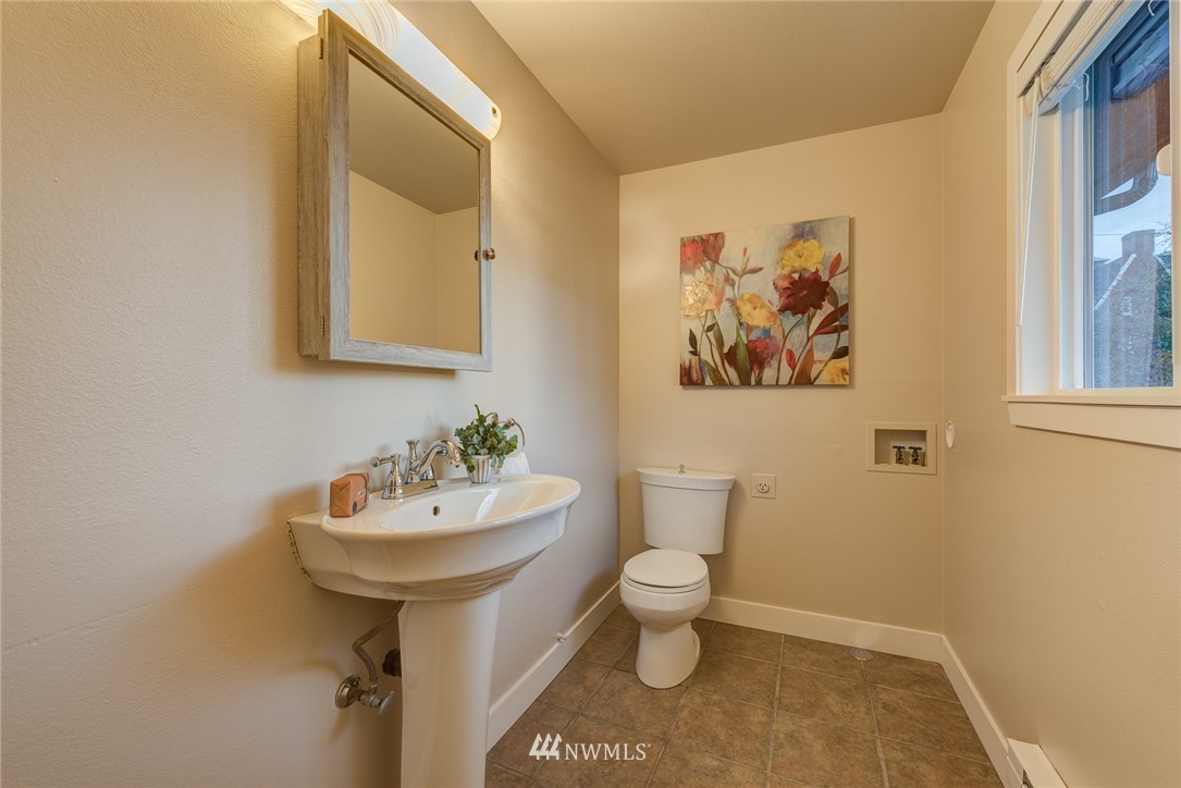 4314 Southwest Frontenac Street Seattle, WA 98136 - Photo 18 of 32 a bathroom with a sink mirror and toilet