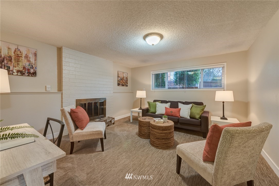 4314 Southwest Frontenac Street Seattle, WA 98136 - Photo 19 of 32 a living room with furniture and a fireplace