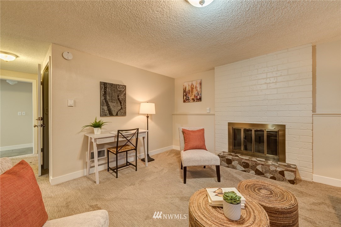 4314 Southwest Frontenac Street Seattle, WA 98136 - Photo 20 of 32 a living room with furniture and a fireplace