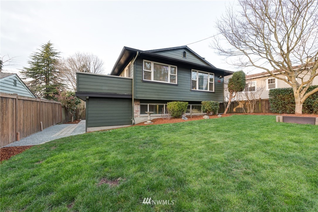 4314 Southwest Frontenac Street Seattle, WA 98136 - Photo 2 of 32 a front view of a house with a garden