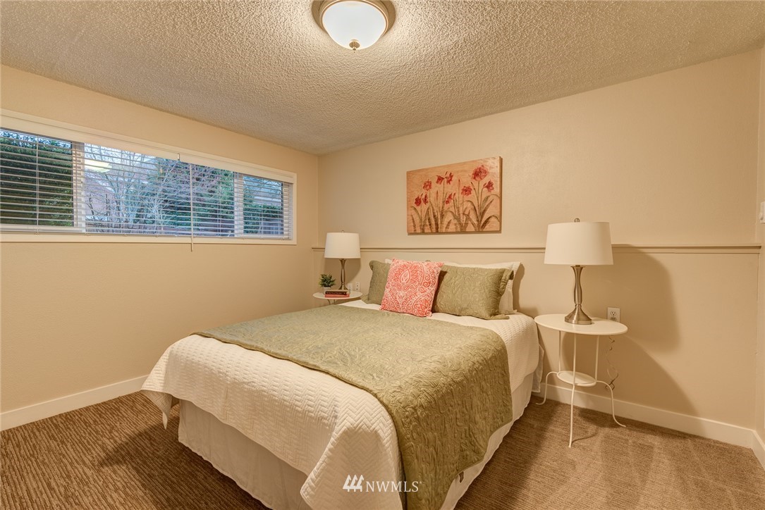 4314 Southwest Frontenac Street Seattle, WA 98136 - Photo 22 of 32 a bedroom with a bed and wooden floor