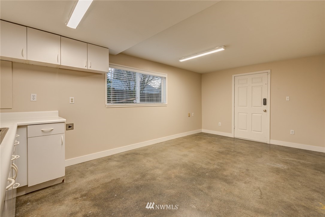 4314 Southwest Frontenac Street Seattle, WA 98136 - Photo 25 of 32 a view of an empty room with a kitchen