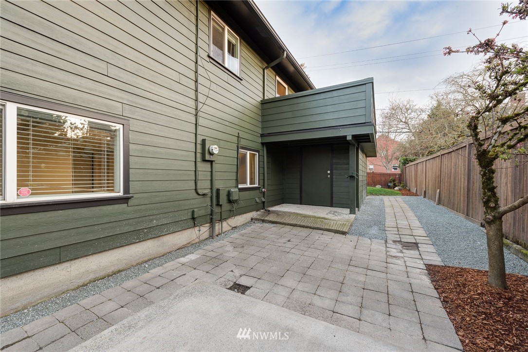 4314 Southwest Frontenac Street Seattle, WA 98136 - Photo 27 of 32 a view of a house with a yard and sitting area
