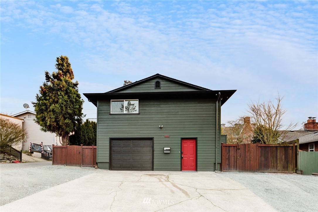 4314 Southwest Frontenac Street Seattle, WA 98136 - Photo 4 of 32 a front view of a house with a garage