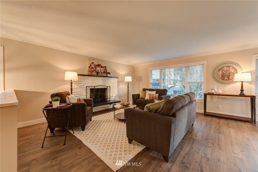 4314 Southwest Frontenac Street Seattle, WA 98136 - Photo 6 of 32 a living room with furniture and a fireplace