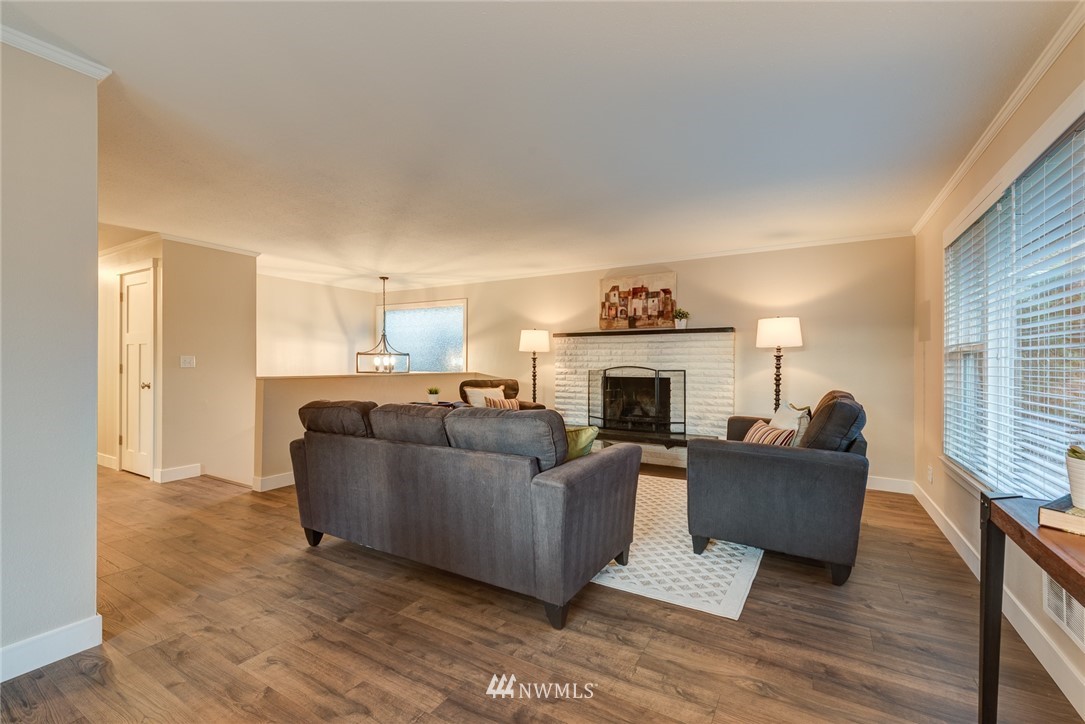 4314 Southwest Frontenac Street Seattle, WA 98136 - Photo 7 of 32 a living room with furniture and a fireplace