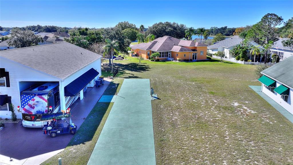 1044 Caravan Loop Polk City, FL 33868 - Photo 1 of 2 an aerial view of a house with a yard basket ball court and outdoor seating