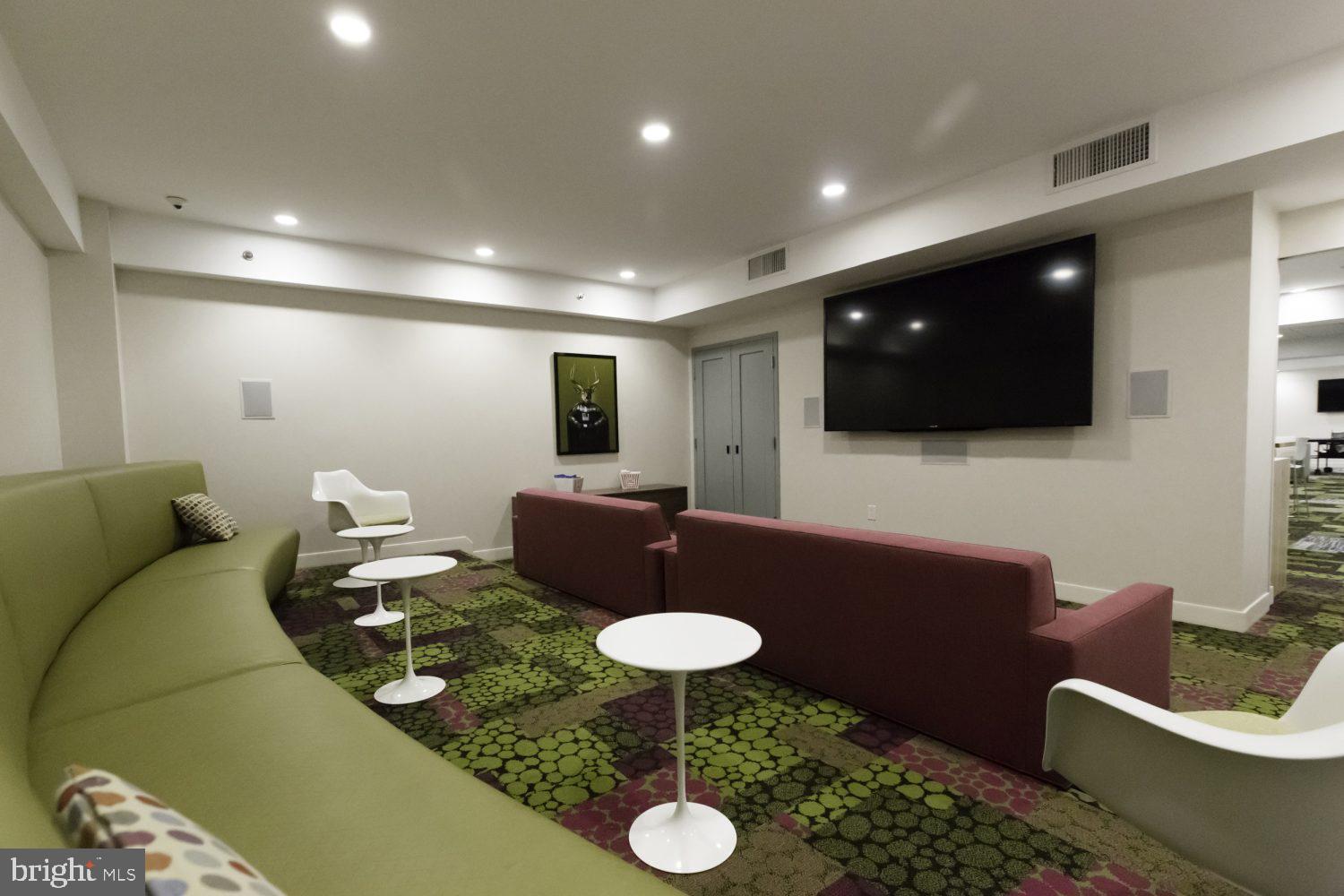 42 South 15th Street, Unit 0B0810 Philadelphia, PA 19102 - Photo 29 of 36 a living room with furniture and a flat screen tv