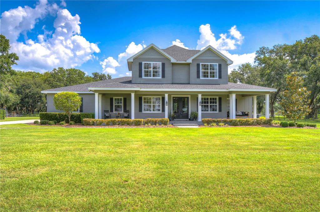 18010 Bledsoe Loop Lithia, FL 33547 - Photo 1 of 1 a front view of a house with swimming pool having outdoor seating