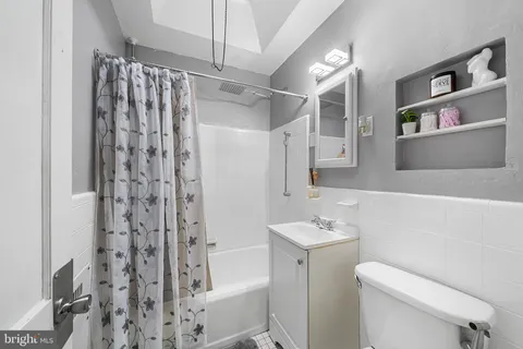 a bathroom with a shower curtain and a sink