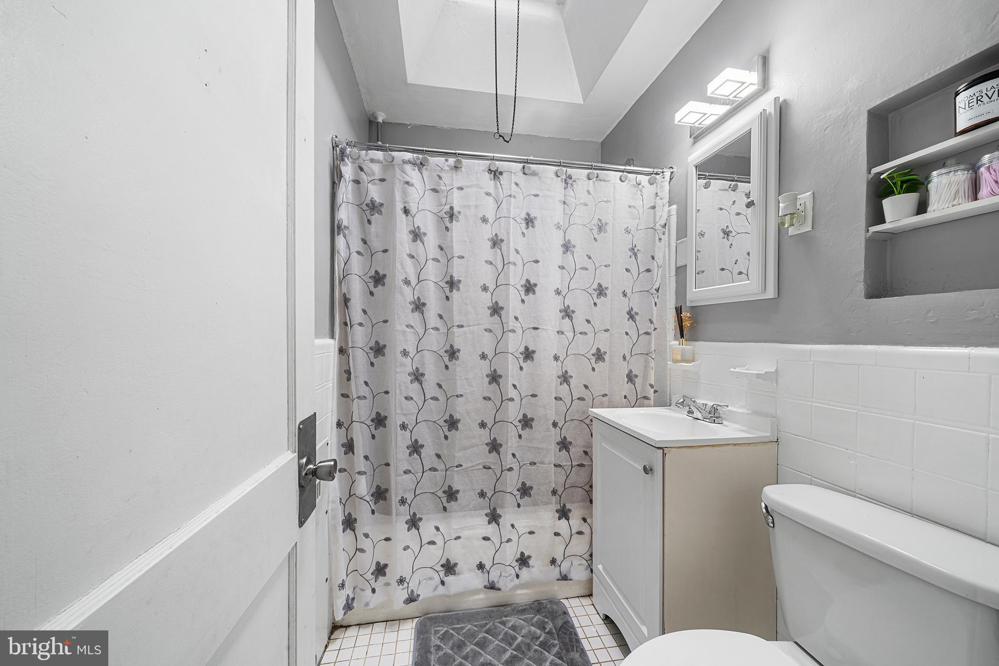 223 St Laurence Road Upper Darby, PA 19082 - Photo 15 of 32 a bathroom with a toilet and a shower curtain