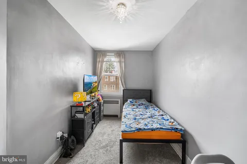 a bedroom with furniture and a window