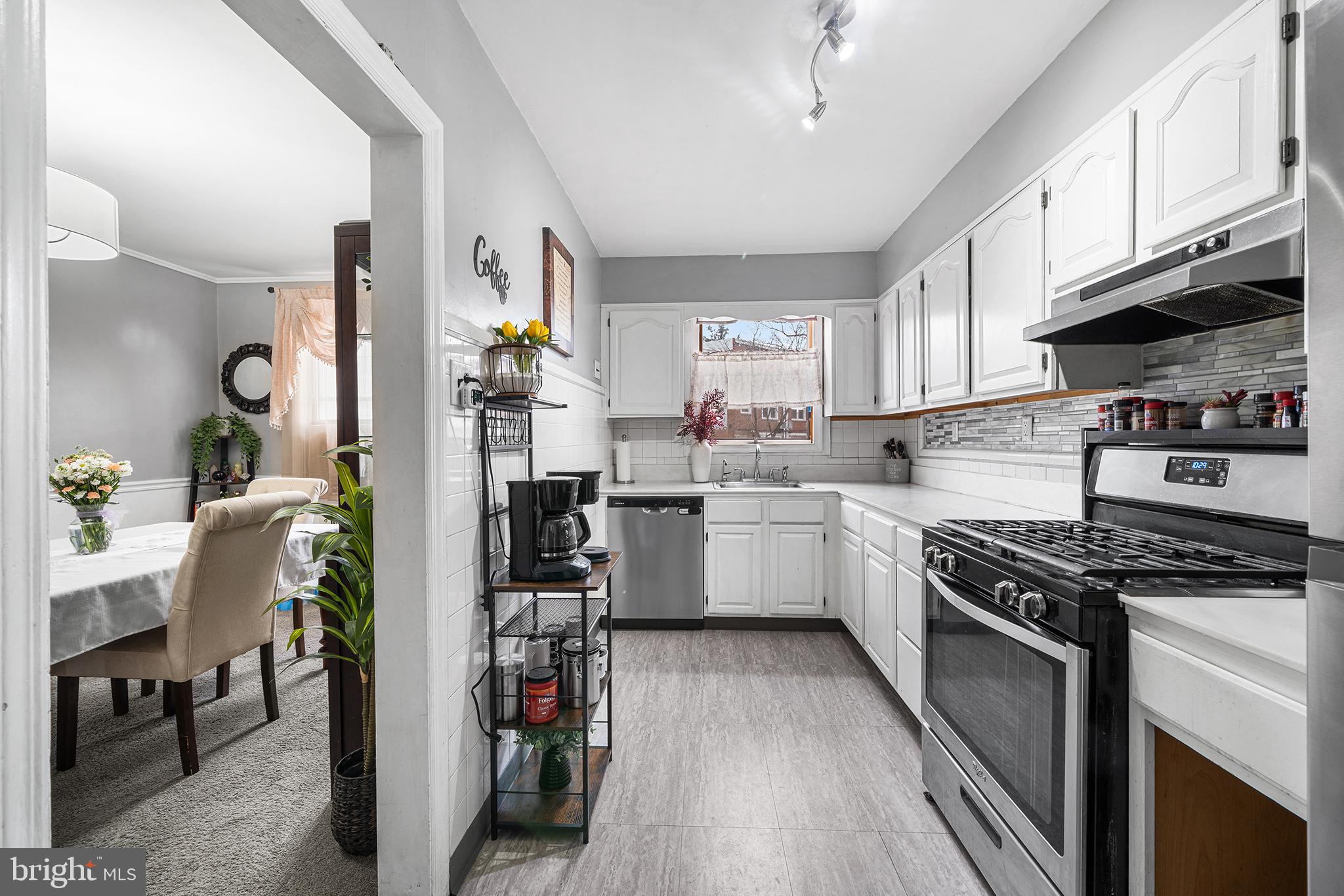 223 St Laurence Road Upper Darby, PA 19082 - Photo 8 of 32 a kitchen with granite countertop a stove a sink dishwasher and a refrigerator