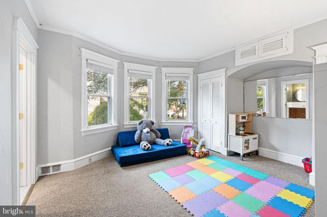 a bedroom with a bed and windows