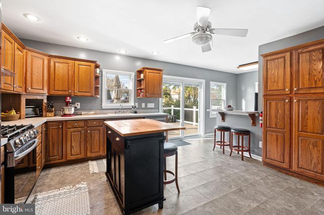 a kitchen with large cabinets appliances and a window
