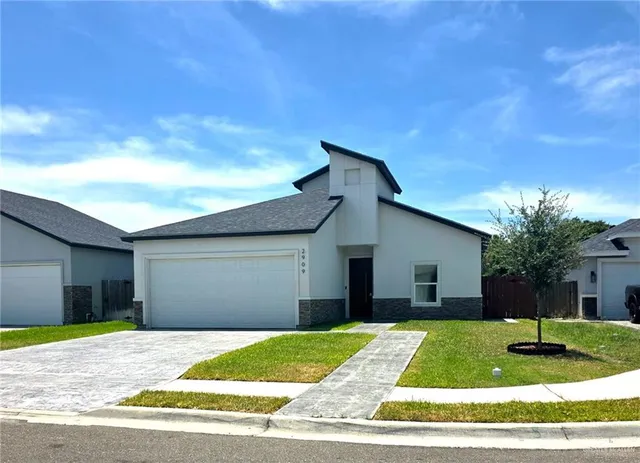 a view of a yard in front of a house with garage