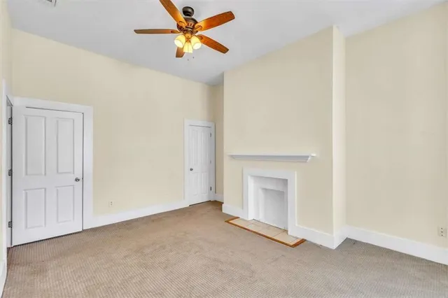 a view of empty room with fireplace
