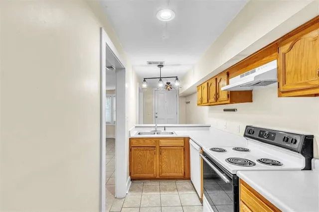 a kitchen with a stove a sink and a microwave