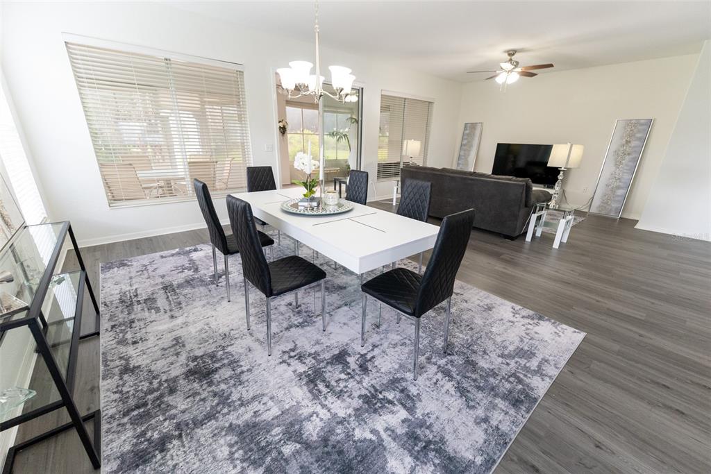 12855 Southeast 92nd Court Road Summerfield, FL 34491 - Photo 11 of 61 a view of a dining room with furniture and wooden floor