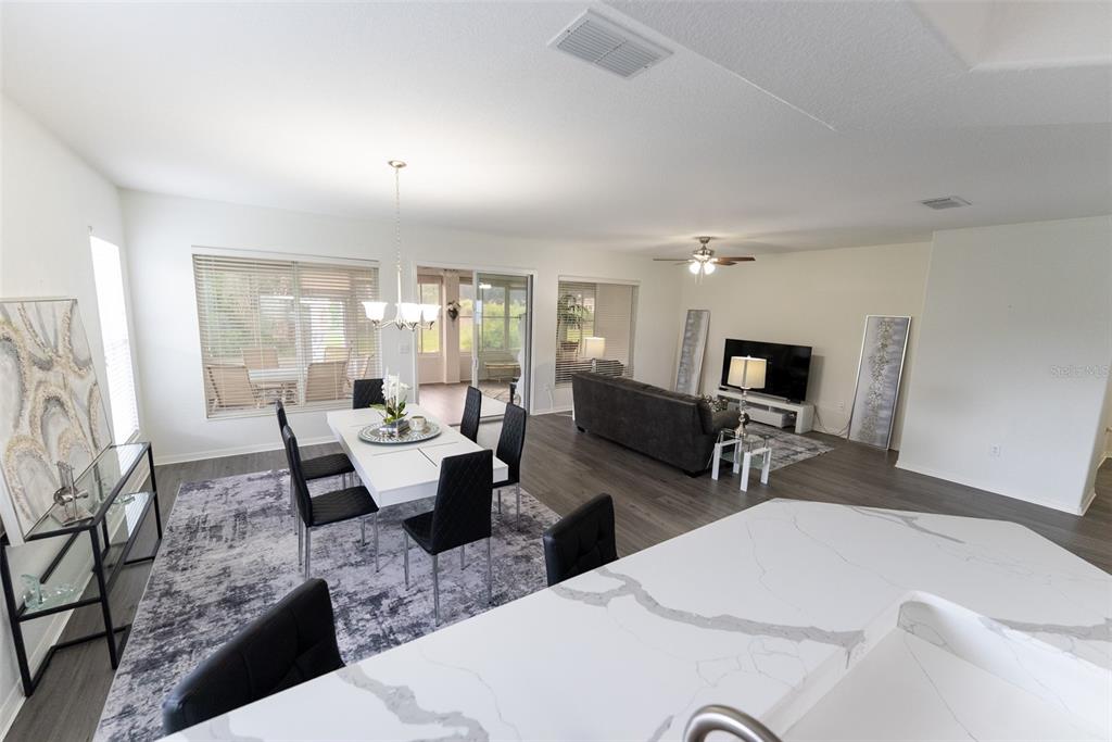 12855 Southeast 92nd Court Road Summerfield, FL 34491 - Photo 12 of 61 a living room with patio furniture and a flat screen tv