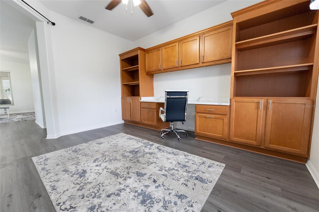 12855 Southeast 92nd Court Road Summerfield, FL 34491 - Photo 22 of 61 a workspace with furniture area and wooden floor