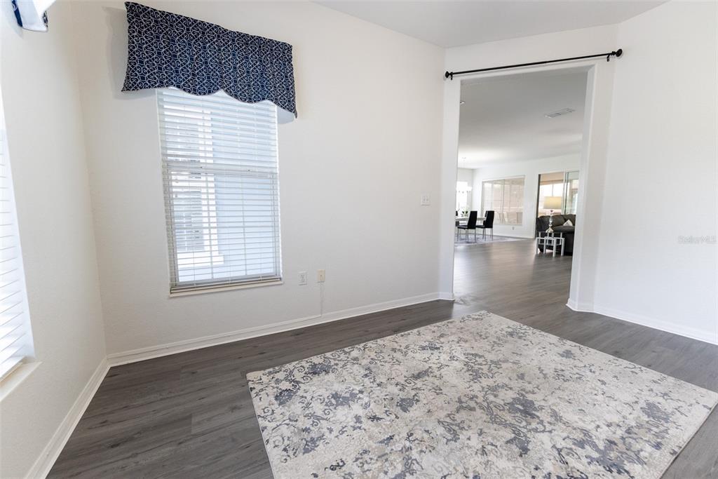 12855 Southeast 92nd Court Road Summerfield, FL 34491 - Photo 23 of 61 a view of a bedroom with wooden floor and a window