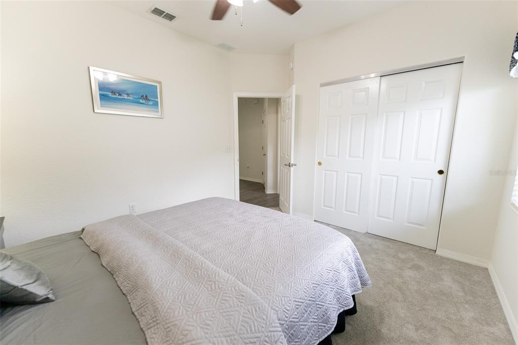 12855 Southeast 92nd Court Road Summerfield, FL 34491 - Photo 29 of 61 a bedroom with a bed and a walk in closet