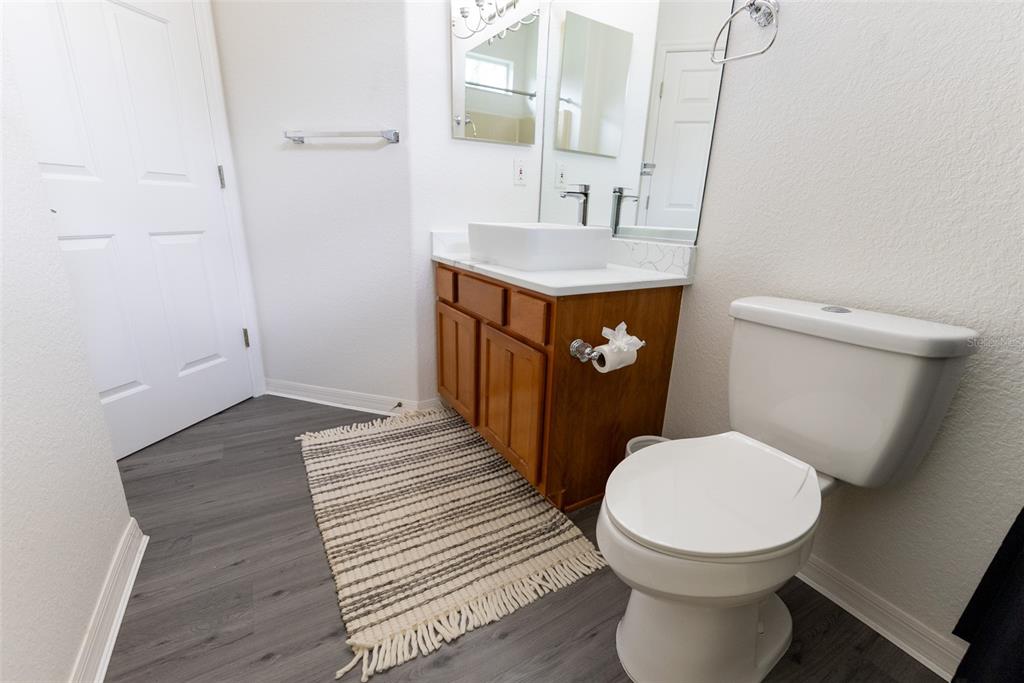 12855 Southeast 92nd Court Road Summerfield, FL 34491 - Photo 32 of 61 a bathroom with a toilet a sink and mirror