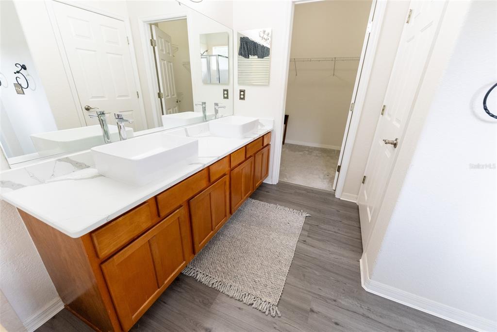 12855 Southeast 92nd Court Road Summerfield, FL 34491 - Photo 41 of 61 a bathroom with a sink a mirror and a shower