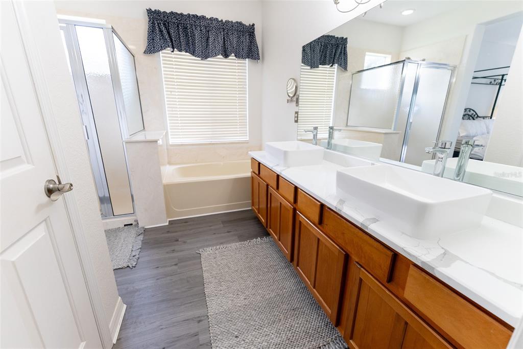 12855 Southeast 92nd Court Road Summerfield, FL 34491 - Photo 42 of 61 a bathroom with a double vanity sink and mirror