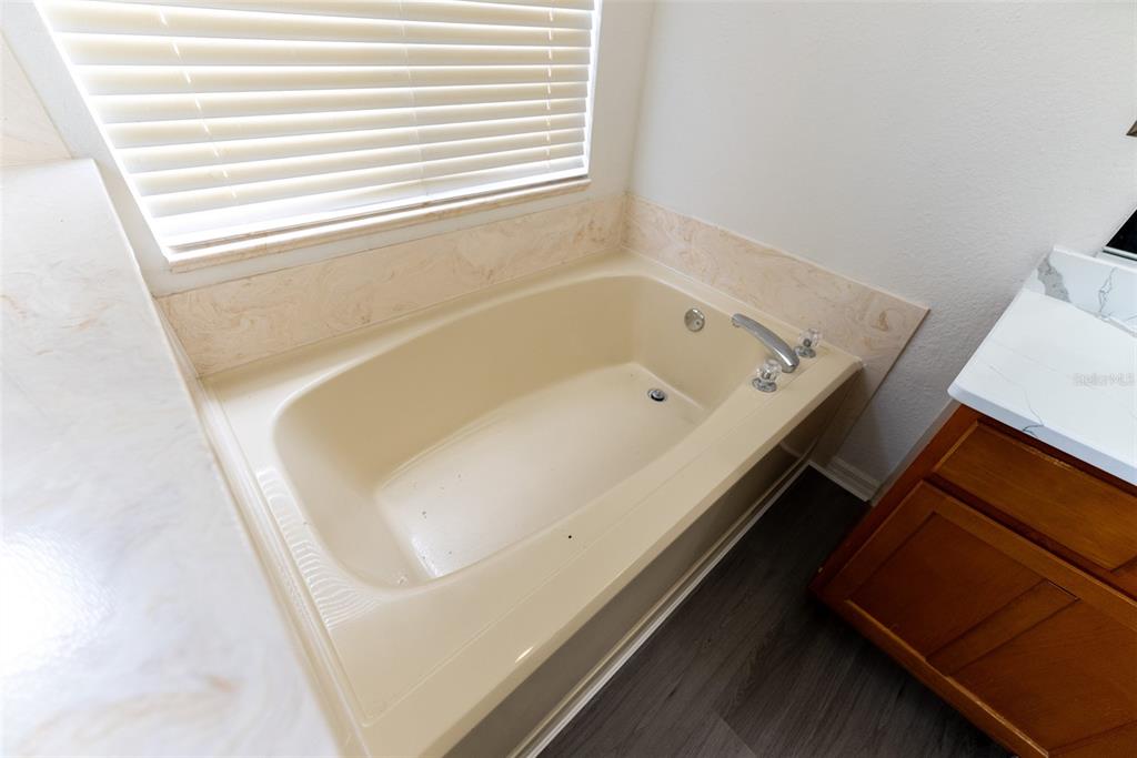 12855 Southeast 92nd Court Road Summerfield, FL 34491 - Photo 45 of 61 a bathroom with a bathtub and a window