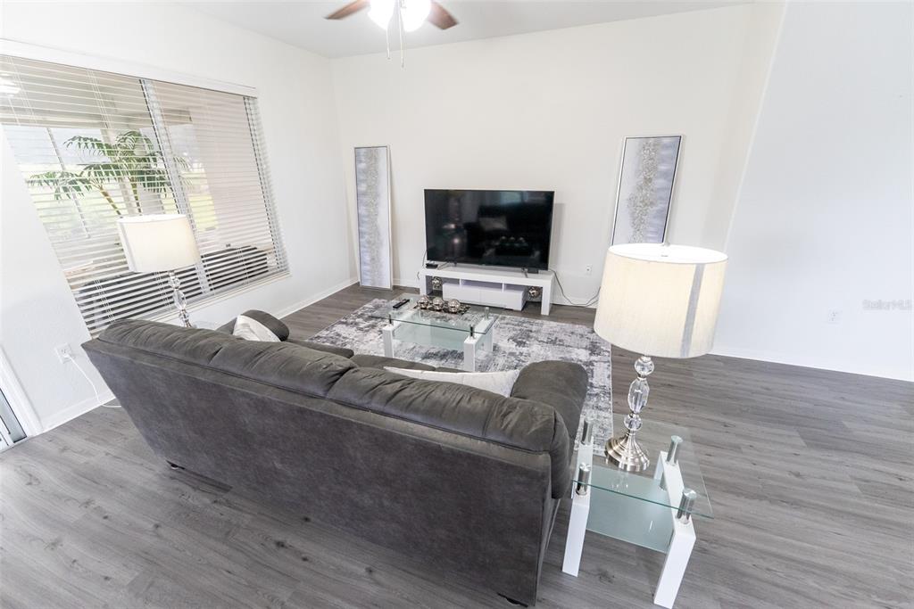 12855 Southeast 92nd Court Road Summerfield, FL 34491 - Photo 5 of 61 a living room with furniture and a flat screen tv