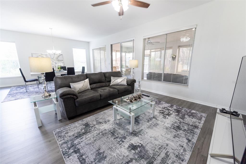 12855 Southeast 92nd Court Road Summerfield, FL 34491 - Photo 6 of 61 a living room with furniture and a large window