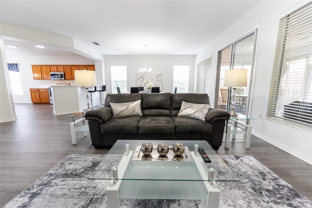 12855 Southeast 92nd Court Road Summerfield, FL 34491 - Photo 7 of 61 a living room with furniture and a wooden floor