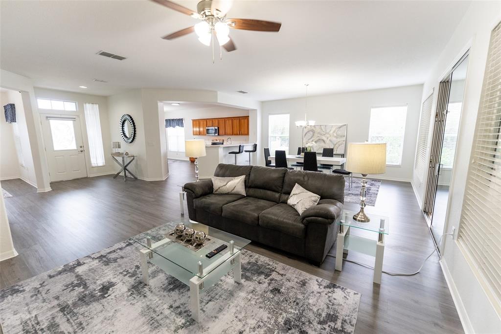 12855 Southeast 92nd Court Road Summerfield, FL 34491 - Photo 8 of 61 a living room with furniture and a wooden floor