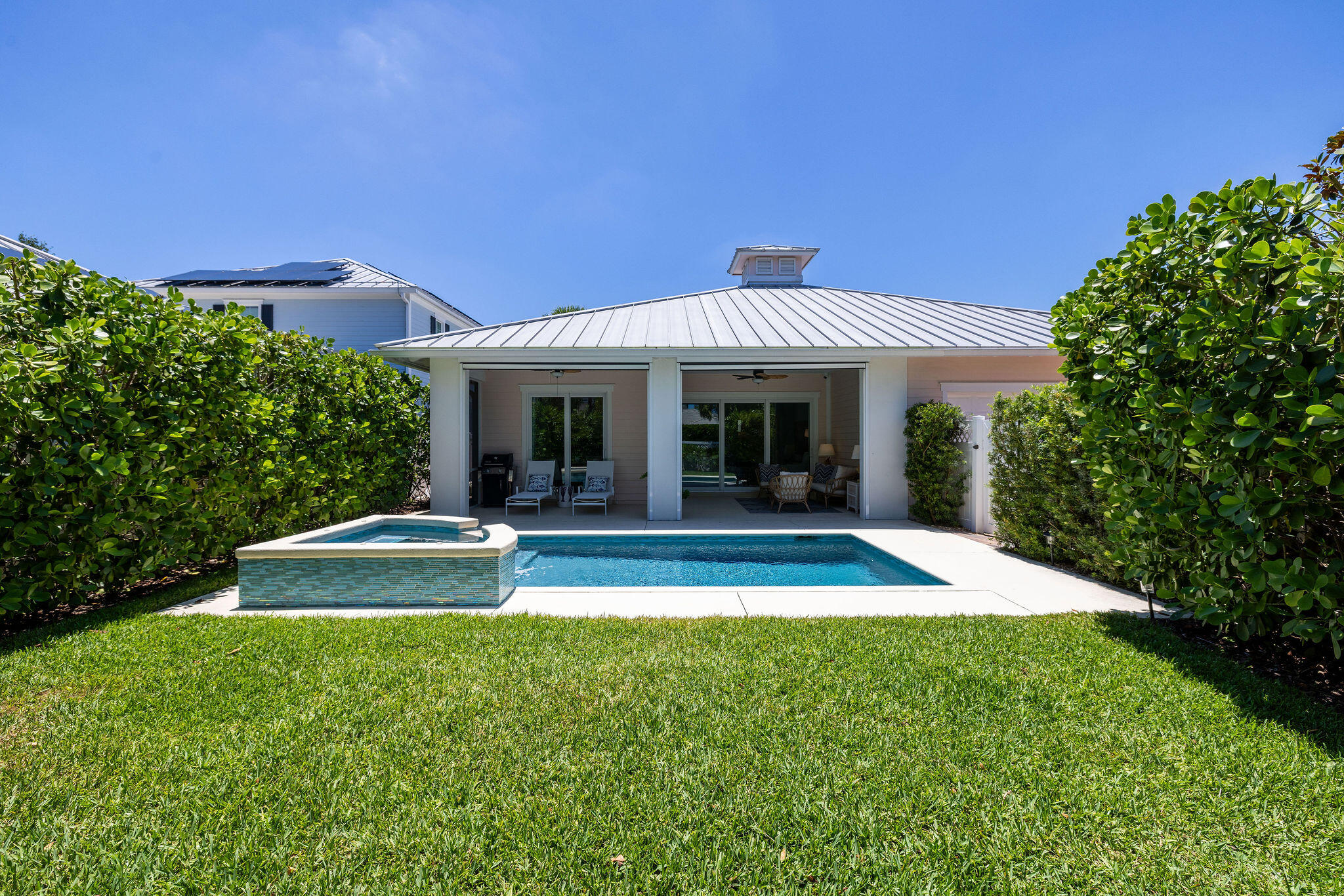 1037 Duval Street Jupiter, FL 33458 - Photo 37 of 47 a view of a house with pool and chairs