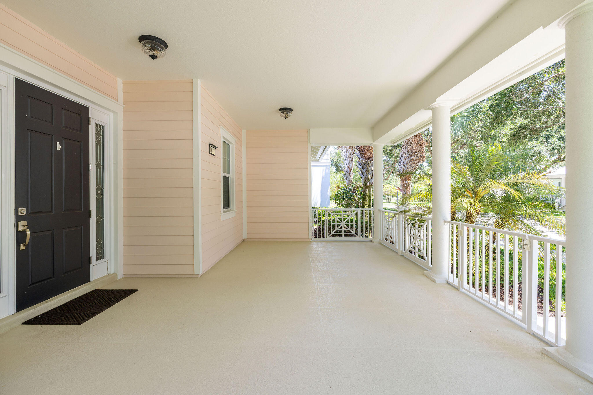 1037 Duval Street Jupiter, FL 33458 - Photo 43 of 47 a view of a porch with wooden floor and front door