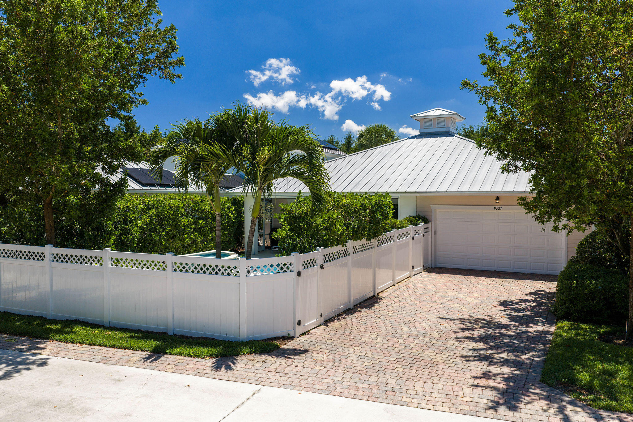 1037 Duval Street Jupiter, FL 33458 - Photo 45 of 47 a view of a house and a yard and a large tree center