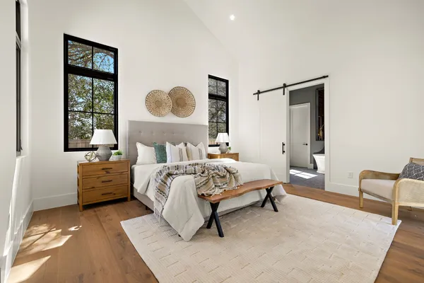 a bedroom with a bed and a painting on the wall