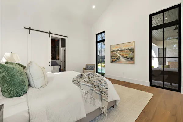 a bedroom with a large bed and a couch