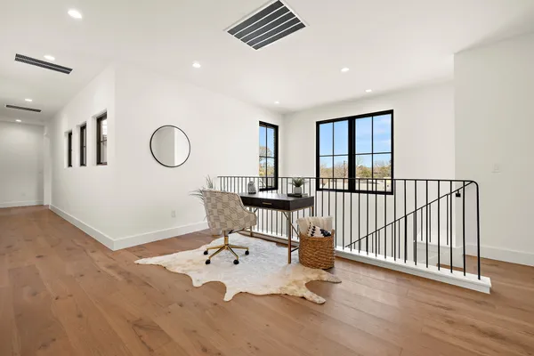 a bathroom with a toilet a sink a tub and mirror