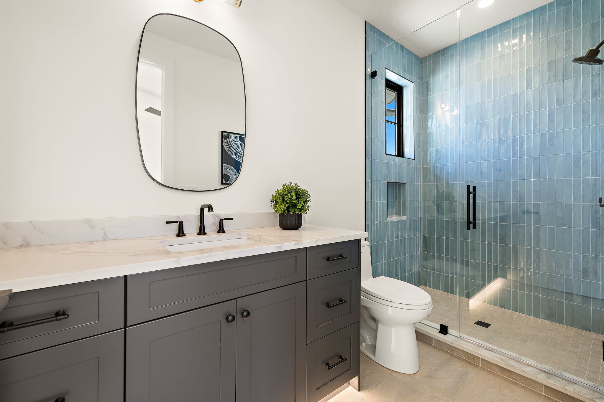 5906 Rickey Drive Austin, TX 78757 - Photo 30 of 38 a bathroom with a toilet a sink a tub and mirror