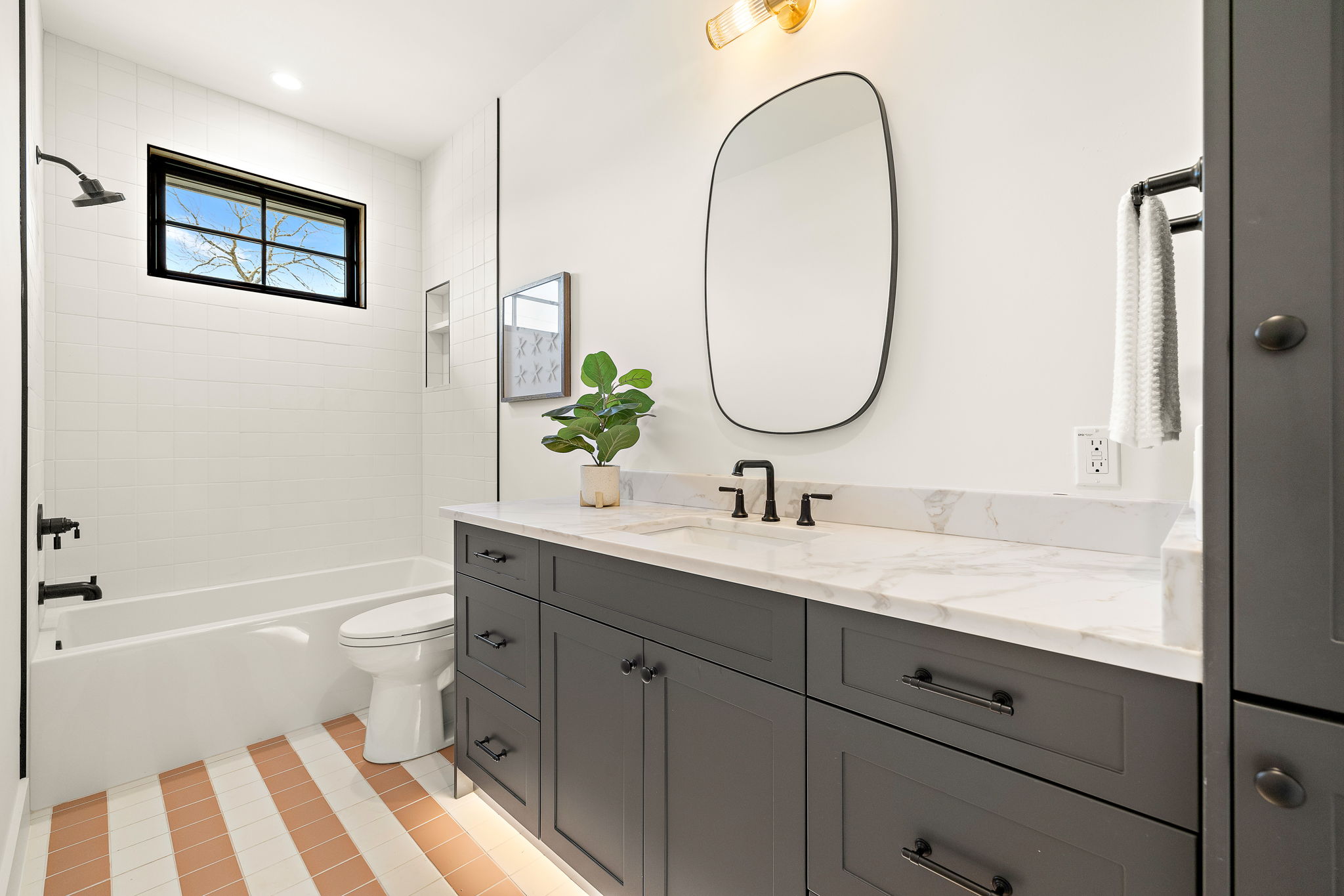 5906 Rickey Drive Austin, TX 78757 - Photo 32 of 38 a bathroom with a granite countertop toilet a sink and a mirror